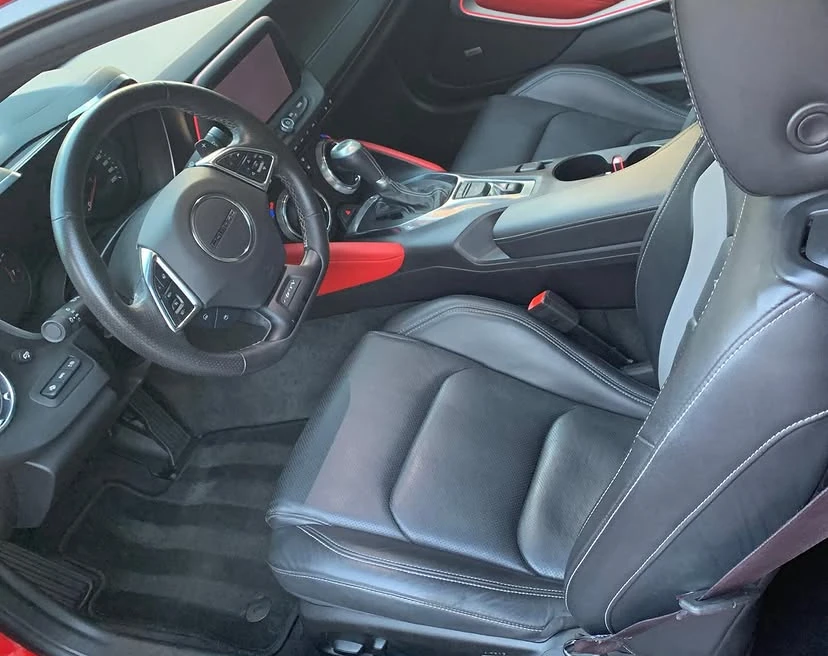Clean black leather Camaro interior detailed by Peak Shine